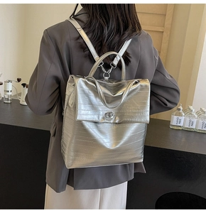 Silver crocodile textured backpack shown on a model for daily fashion street style
