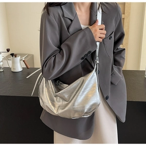 Detailed view of silver metallic slouchy tote bag with a soft pleated texture design