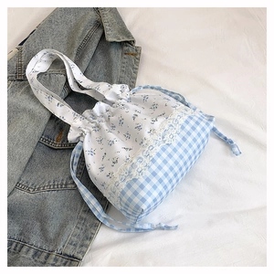 Detailed view of floral pattern bucket bag with white lace trim and drawstring closure