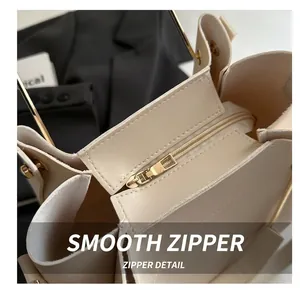 Top view of beige handbag showing smooth zipper compartment and large interior capacity