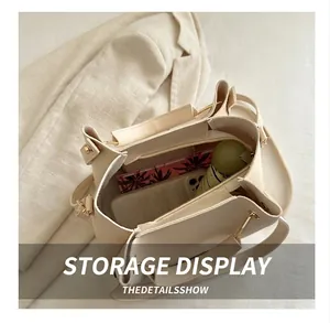 Top view of large cream tote bag showing spacious interior with pockets and daily items