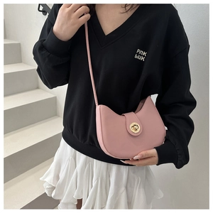 Pink half-moon crossbody bag featuring a golden twist lock and a smooth leather finish