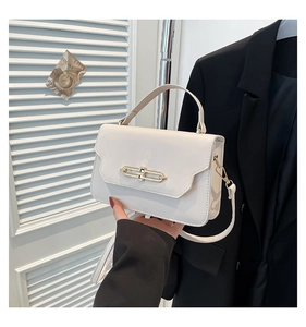 Detail of white vintage leather handbag with elegant gold clasp and handle for women