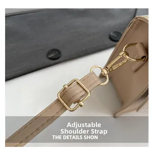 Detailed view of the adjustable beige leather strap with elegant gold metal hardware