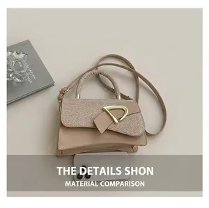 Detail of beige box bag showing straw texture flap and gold D-ring buckle