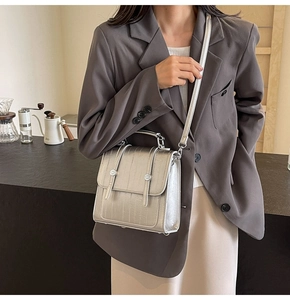 Silver metallic crocodile pattern handbag styled with a structured grey blazer