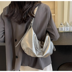 Detail of silver metallic hobo bag with crocodile texture and adjustable shoulder strap