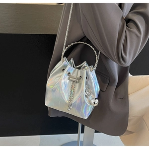 Detail of silver holographic bucket bag with ring handle and metal chain strap