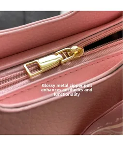 Detail of pink lychee leather bag with smooth hardware zipper puller for durability