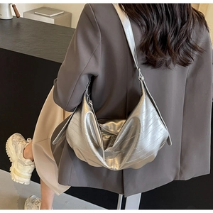 Detail showing the pleated texture and metallic silver finish of the oversized hobo bag