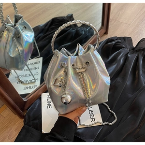 Detailed macro of holographic silver bucket bag with metal handle and drawstring finish