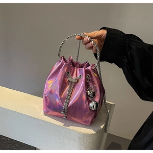 Close-up of metallic purple bucket bag with rhinestone handle and heart charm details