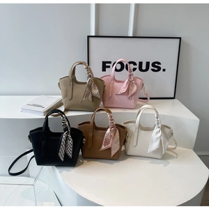Detailed arrangement of textured bucket bags in five colors with silk scarf handles