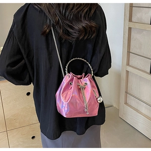 Detail of pink laser bucket bag with metallic ring handle and silver chain strap