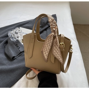 Detail of khaki bucket bag with lychee texture and geometric pattern silk scarf