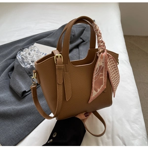 Brown lychee leather bucket bag with pink floral scarf and gold hardware detail