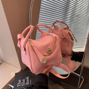 Sac seau rose en cuir grainé avec poignées supérieures et boucle métallique élégante