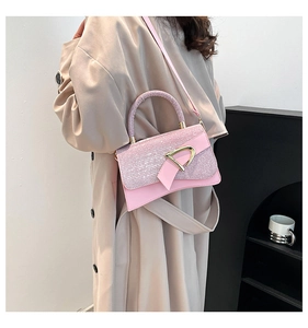 Detail of pink sequin flap and golden D-shaped buckle on stylish crossbody bag