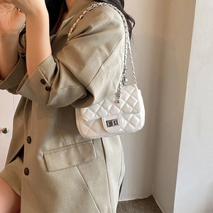 Elegant white quilted crossbody bag with silver chain strap and classic twist lock closure