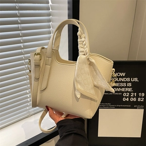 Chic cream white leather bucket bag with silk scarf on handle for modern women