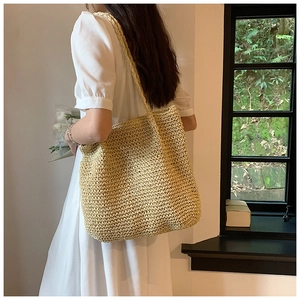 Detail of straw woven tote bag texture on a shoulder bag for summer beach fashion