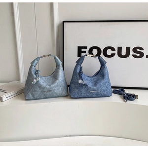 Close-up of denim quilted handbags with JINGPIN metal logo and unique circular handles