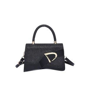 Chic black sequin hourglass handbag with gold D-buckle and detachable shoulder strap