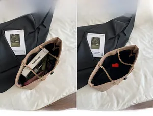 Detail view of the large capacity tote bag interior with beige quilted texture and chain strap