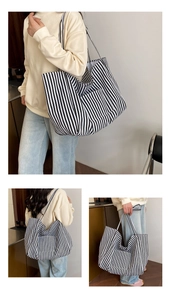 Detailed views of a large black and white striped canvas tote bag worn by a model