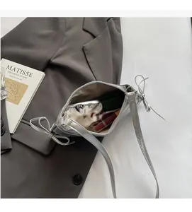 Top view showing the spacious interior of the silver metallic tote with bow details