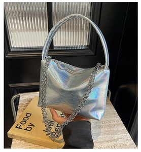 Detail of silver holographic shoulder bag with metallic chain and crinkled texture