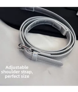 Detail view of the adjustable silver PU leather shoulder strap with a metallic pin buckle