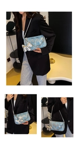 Detail of light blue sequin shoulder bag with silver chain and balloon dog charm