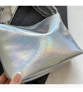 Detail of holographic silver bucket bag showing pleated texture and metal chain strap