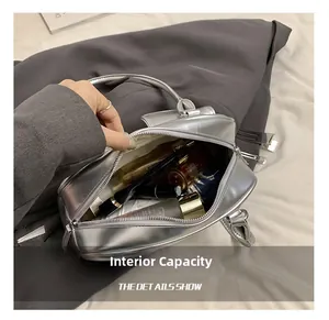 Macro shot showing large interior capacity of silver PU leather handbag for cosmetics