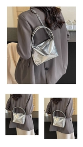 Close-up of metallic silver PU leather bag with wrinkled texture and chain strap