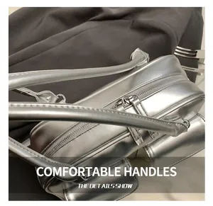 Close-up of a silver metallic tote bag showing premium zipper and sturdy double handles
