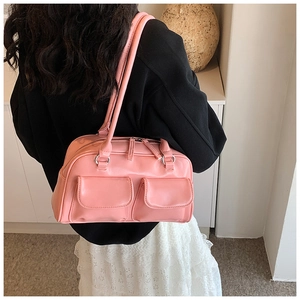 Close-up of pink retro underarm bag with double front pockets and metallic zippers