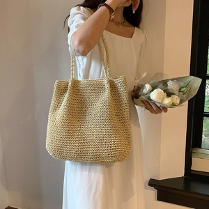 Minimalist straw tote bag for women in natural beige featuring woven texture for summer
