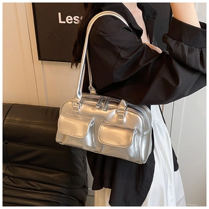 Detail of silver metallic underarm bag with double front flap pockets and slim strap