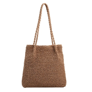 Large brown straw tote bag with woven shoulder straps on a clean white background