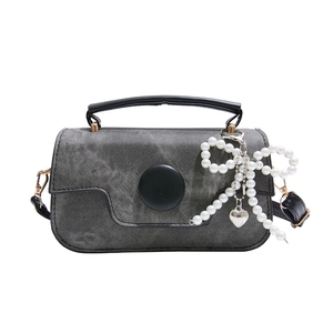 Grey denim crossbody bag with black handles and pearl bow heart charm for women