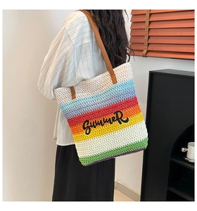 Detail of multi-color striped straw tote bag featuring black Summer embroidery
