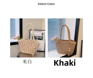 Detail of woven straw shoulder bag with decorative tassel and handcrafted texture
