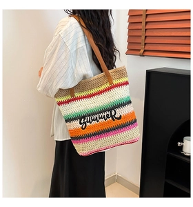 Close-up of woven tote bag with colorful stripes and Summer script embroidery
