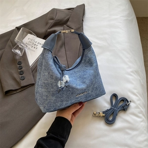 Blue denim dumpling bag with JINGPIN metal logo and beaded tassels for women