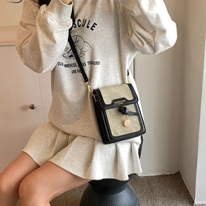 Fashionable khaki and black crossbody bag for women with gold logo and metal pendant