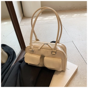 Detail of cream vintage hobo bag with dual front flap pockets and silver-tone hardware