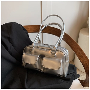 Detail of silver metallic shoulder bag with double pockets and glossy mirror finish