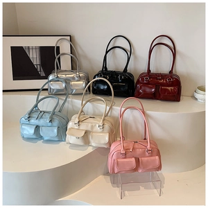 Glossy leather Y2K handbags in six colors displayed on a minimalist white stand